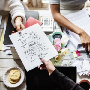 colleagues handing branding plan strategy to other.jpg