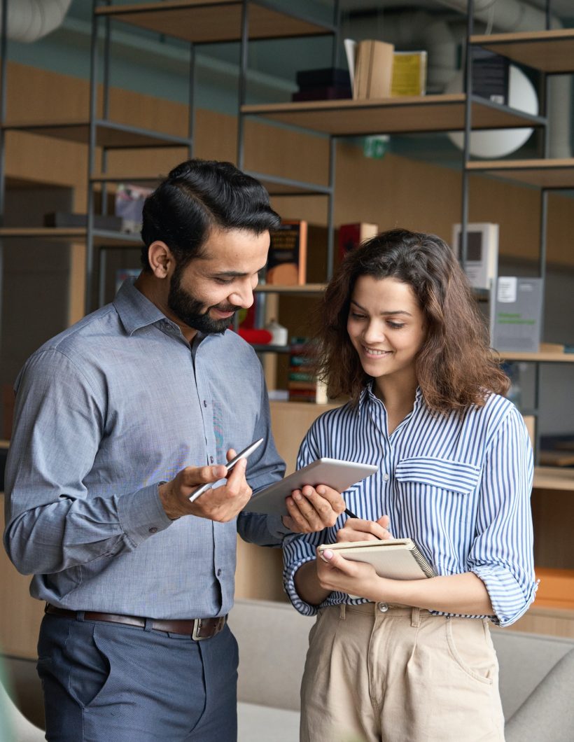 diverse friendly coworkers talking using digital tablet in office .jpg